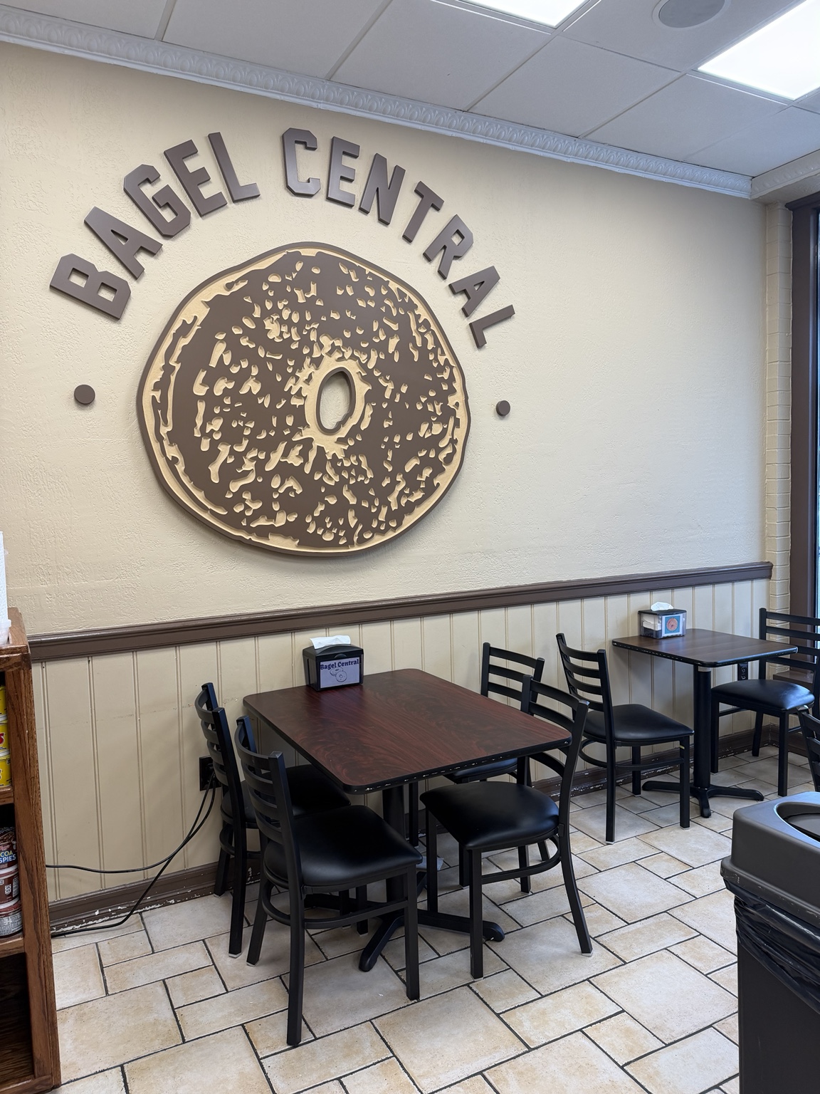 Bagel Central’s seating area and large bagel artwork